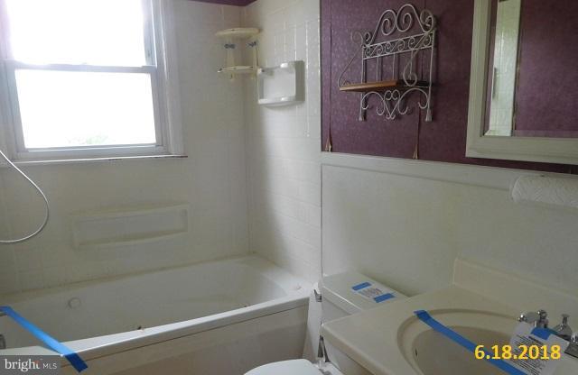 1234 Hillside Road Pasadena, MD 21122 - Photo 7 of 12 a bathroom with a window a sink and a shower