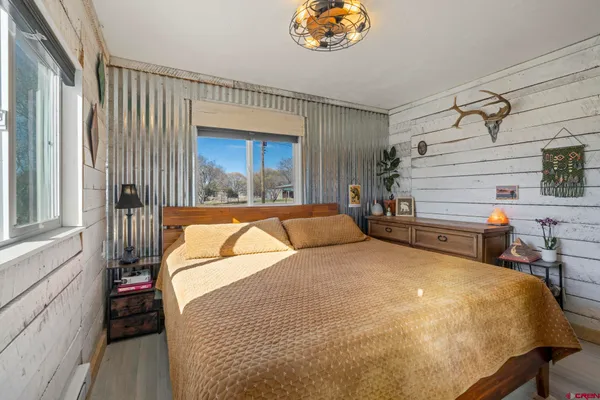 a bed sitting in a room next to a window
