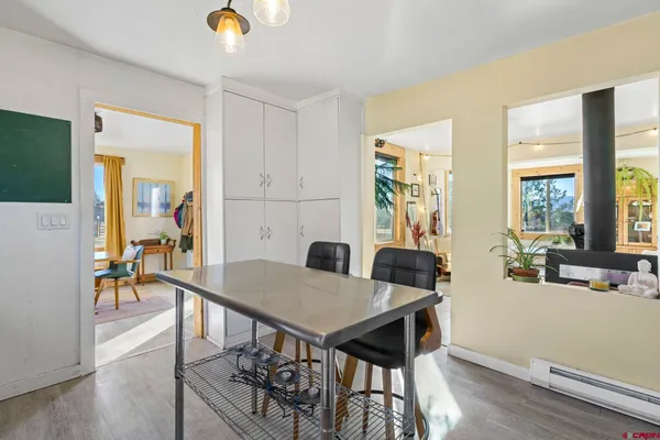 a living room with patio furniture and a large window