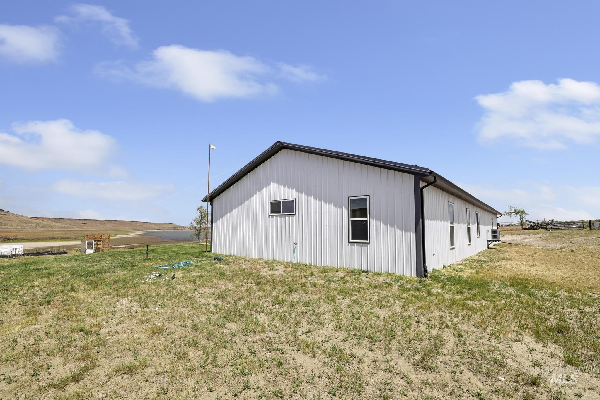 758 Cedar Crk Road Rogerson, ID 83302 - Photo 34 of 50 Contemporary metal building with multiple windows, a dark roofline, and integrated gutters