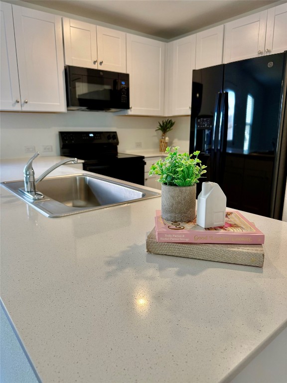 a kitchen with a refrigerator and a sink