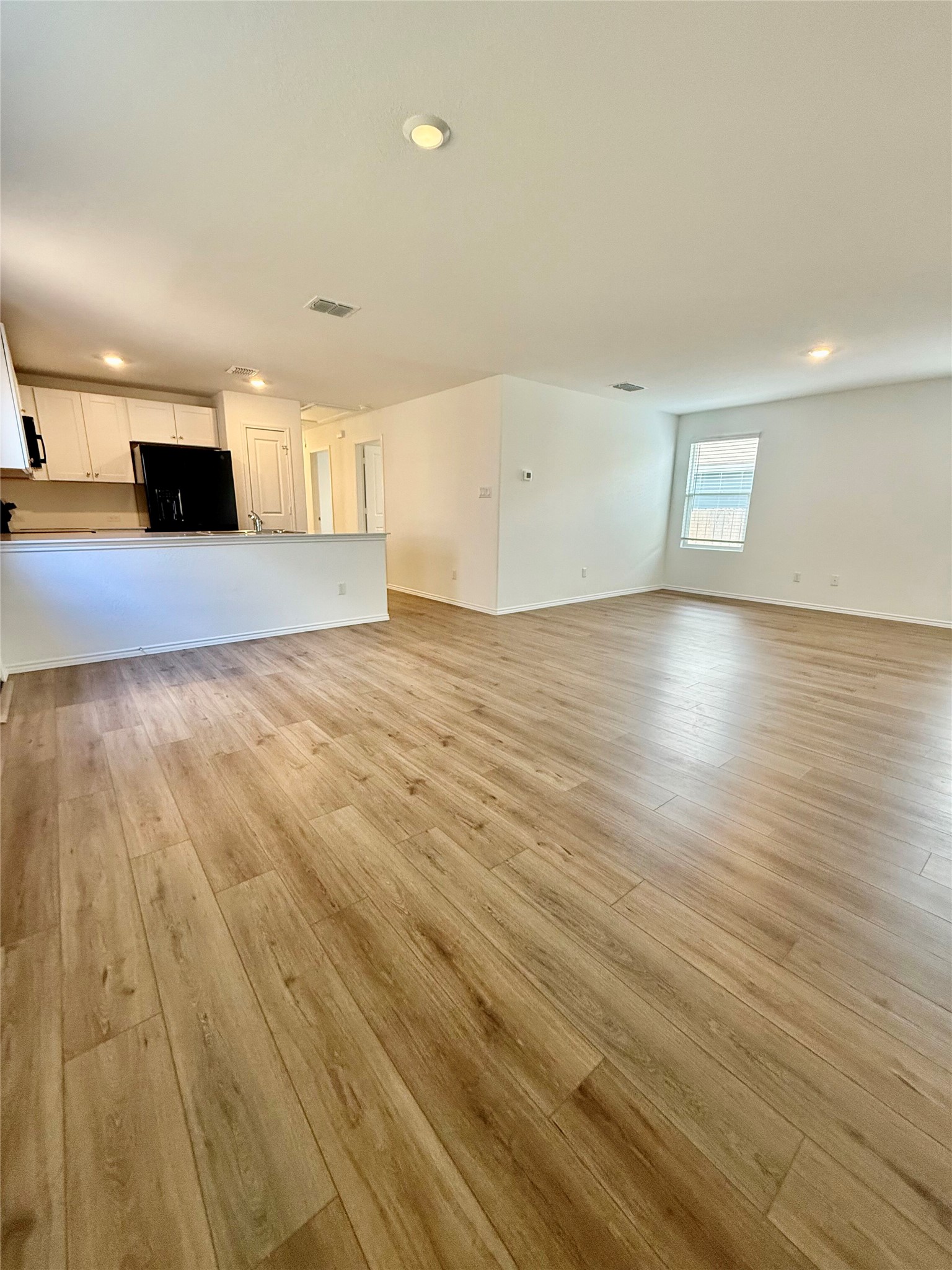 716 Commander Abbott Drive Jarrell, TX 76537 - Photo 7 of 17 a view of empty room with wooden floor