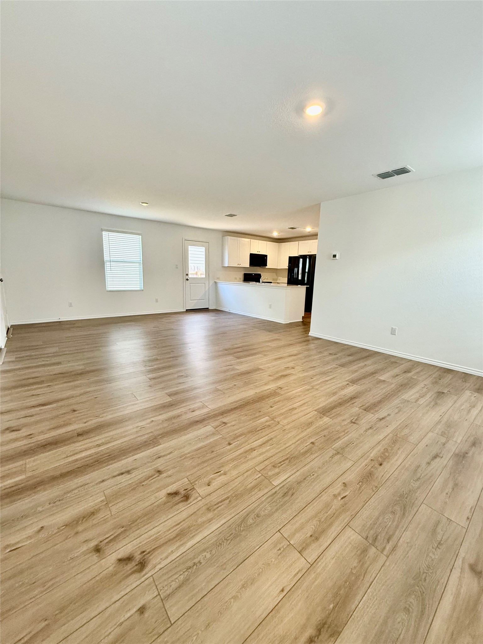 716 Commander Abbott Drive Jarrell, TX 76537 - Photo 8 of 17 a view of empty room with wooden floor