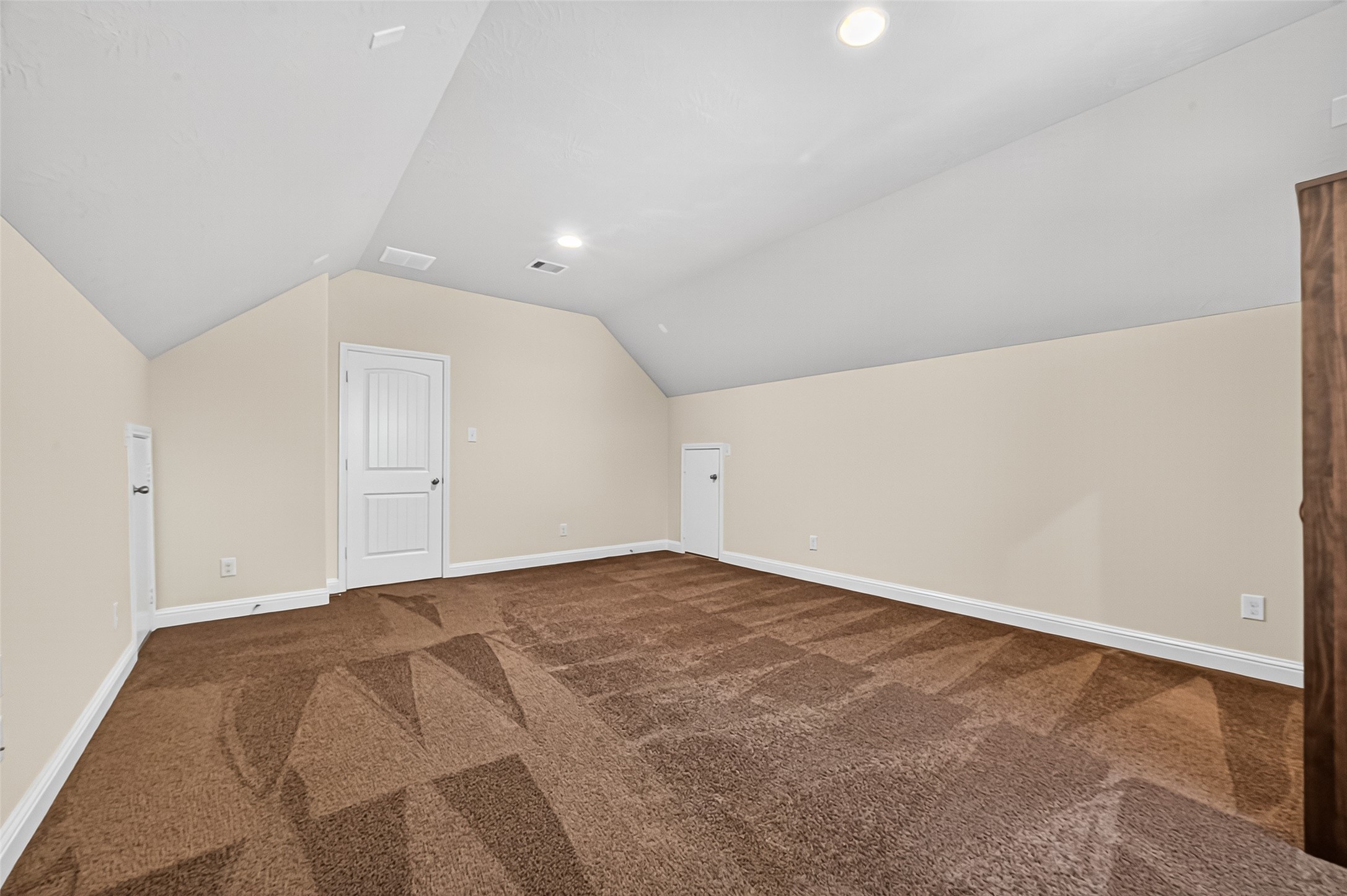 8107 Lockridge Terrace Lane Cypress, TX 77433 - Photo 39 of 50 This second view of the spacious media room highlights its versatility—whether you're setting up a home theater, game room, or fitness area, the possibilities are endless. With high ceilings and plush carpeting, it's a cozy yet open space ready for entertainment or relaxation.