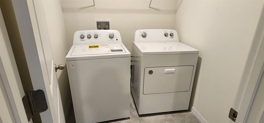 16778 Carlton Pond Street Wimauma, FL 33598 - Photo 16 of 27 a utility room with dryer and washer