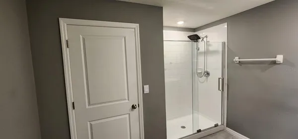 a bathroom with a glass shower door