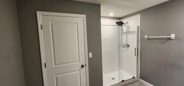 a bathroom with a glass shower door