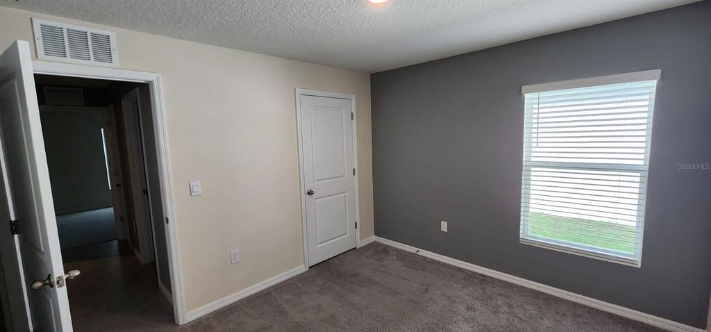 16778 Carlton Pond Street Wimauma, FL 33598 - Photo 21 of 27 a view of an empty room with a window