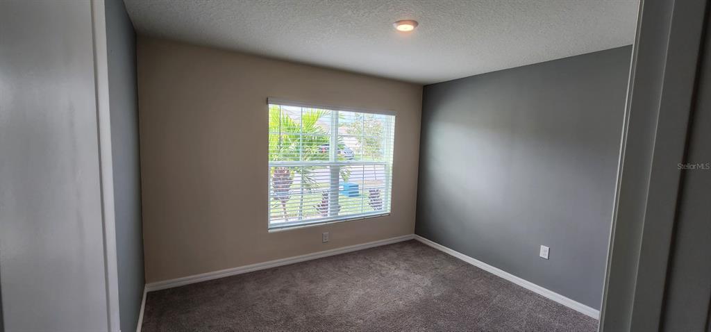 16778 Carlton Pond Street Wimauma, FL 33598 - Photo 23 of 27 an empty room with windows and closet