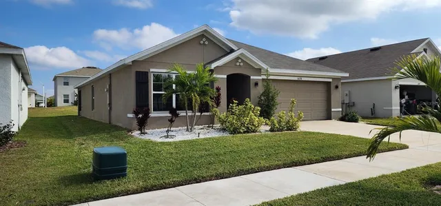 a front view of house with a garden