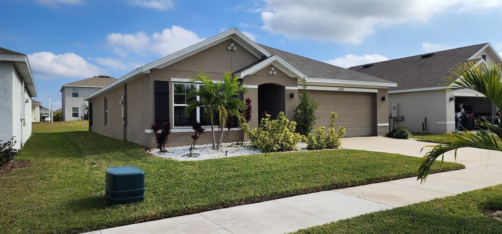 16778 Carlton Pond Street Wimauma, FL 33598 - Photo 5 of 27 a front view of house with a garden