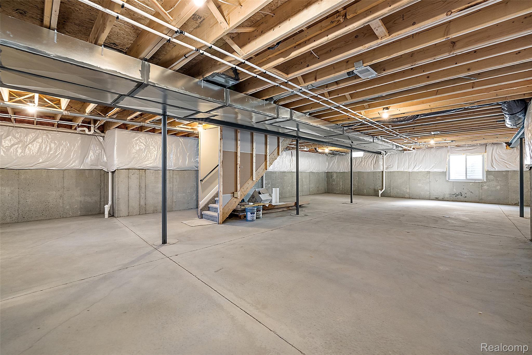 8267 Sandi Lane Romeo, MI 48065 - Photo 45 of 46 Unfinished basement with concrete flooring and exposed wooden joists
