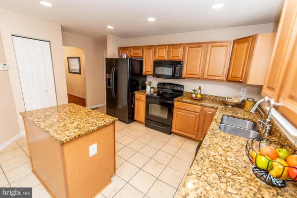 a view of a kitchen with granite countertop cabinets