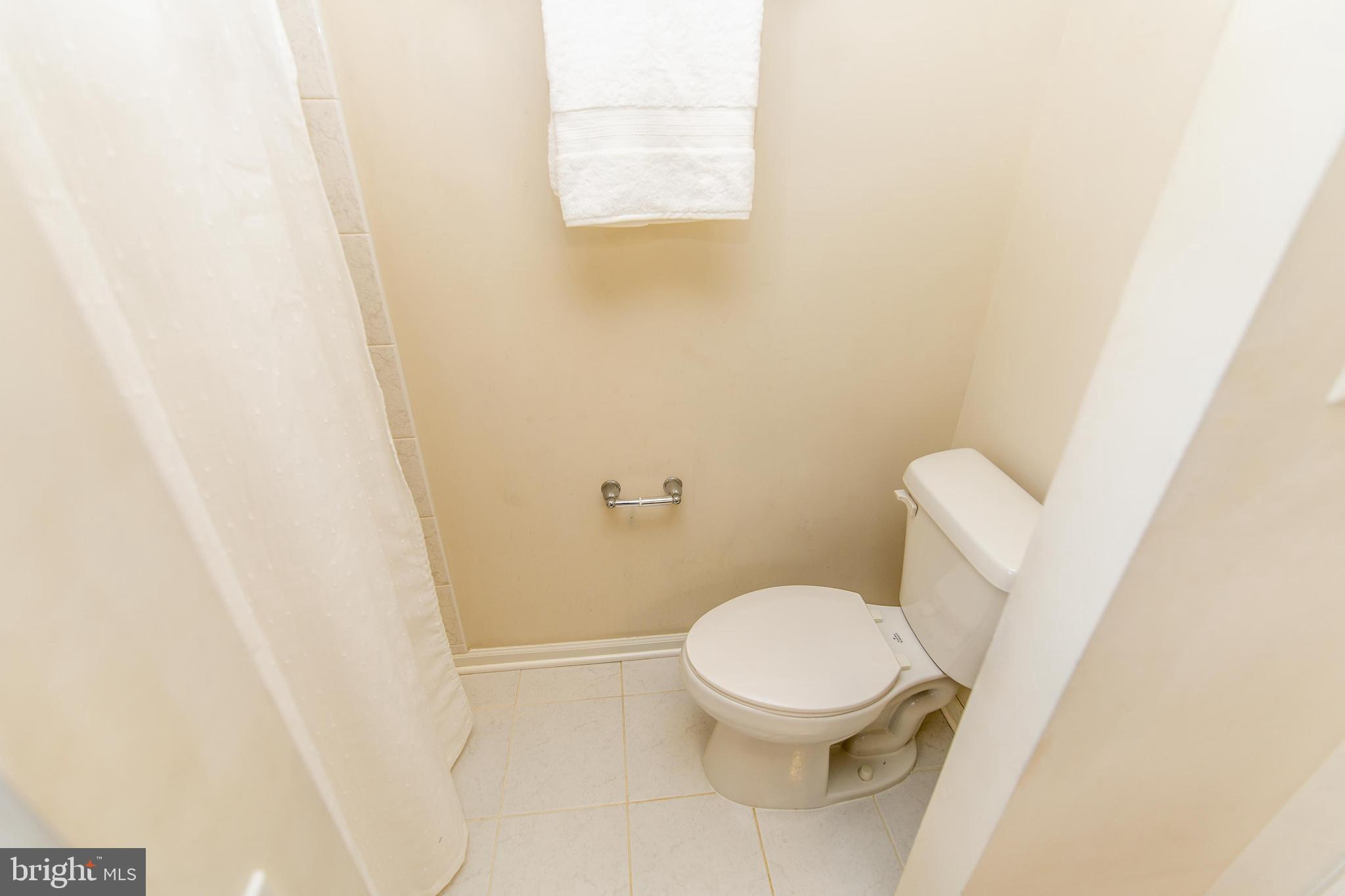 13400 Oaklands Manor Drive Laurel, MD 20708 - Photo 18 of 44 a white toilet sitting next to a shower