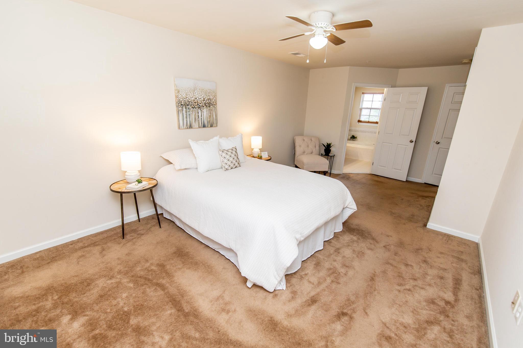 13400 Oaklands Manor Drive Laurel, MD 20708 - Photo 20 of 44 a bedroom with a bed and a chandelier
