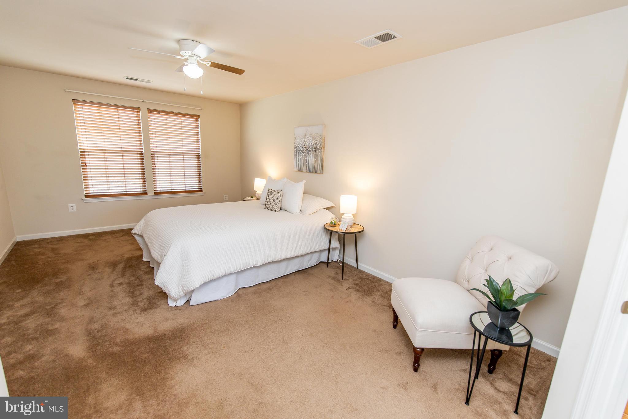 13400 Oaklands Manor Drive Laurel, MD 20708 - Photo 21 of 44 a bedroom with a bed table chair and a window