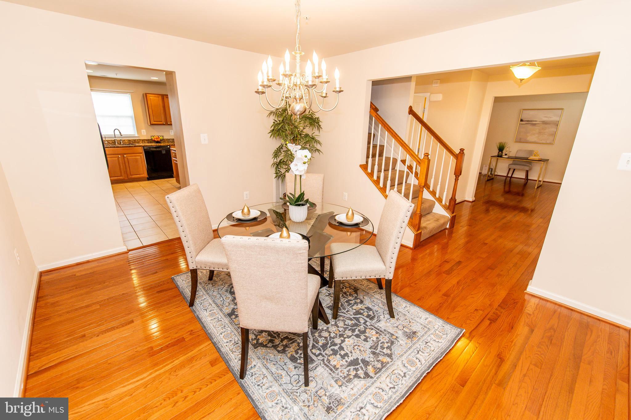 13400 Oaklands Manor Drive Laurel, MD 20708 - Photo 3 of 44 a living room with dining room and wooden floor