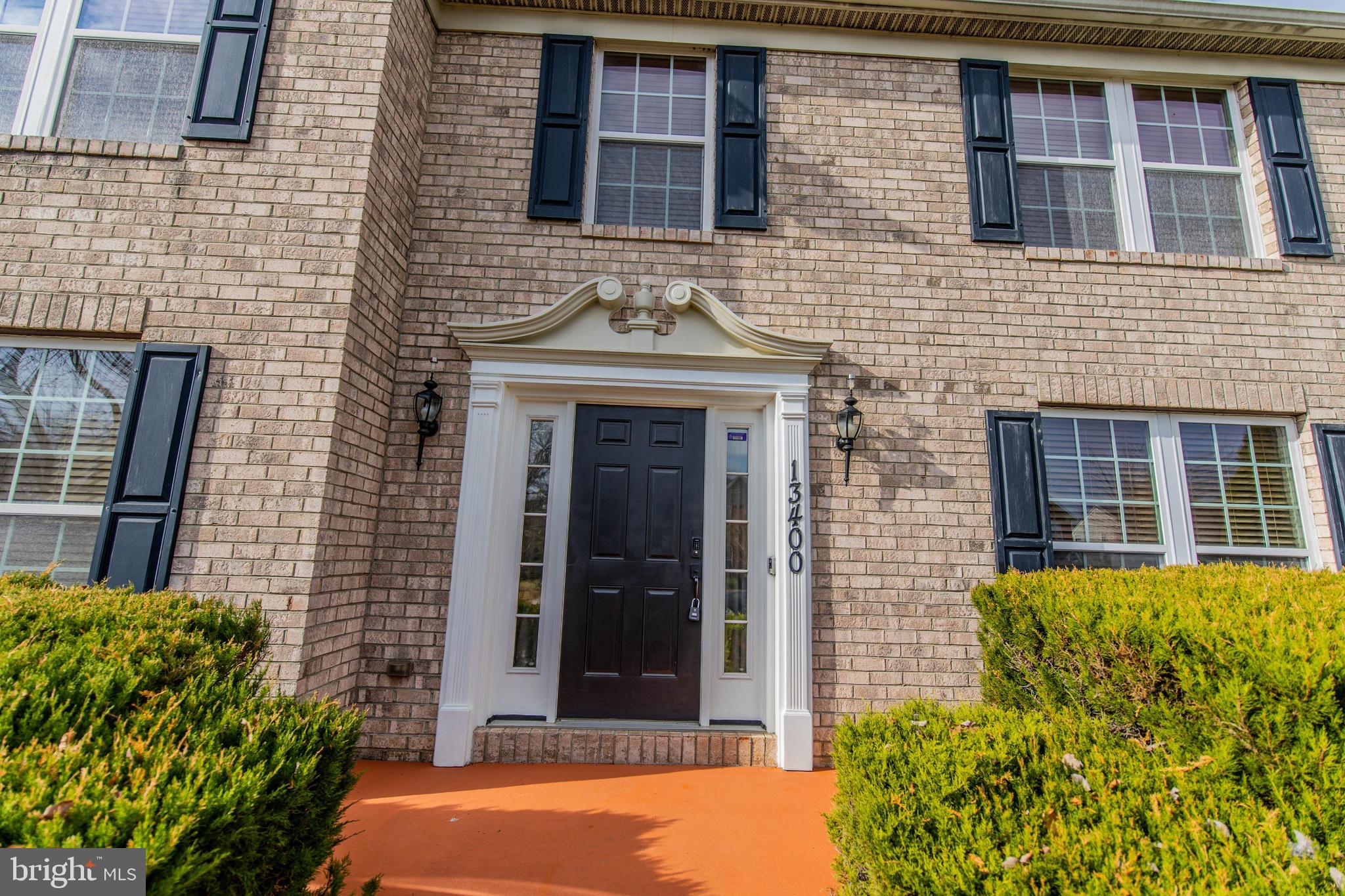 13400 Oaklands Manor Drive Laurel, MD 20708 - Photo 35 of 44 front view of a brick house with a large windows