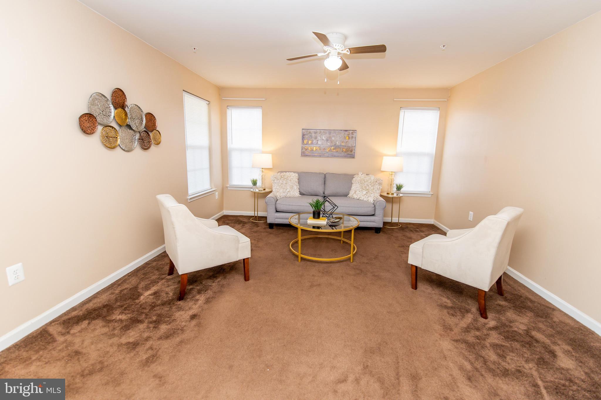 13400 Oaklands Manor Drive Laurel, MD 20708 - Photo 7 of 44 a living room with furniture and a large window