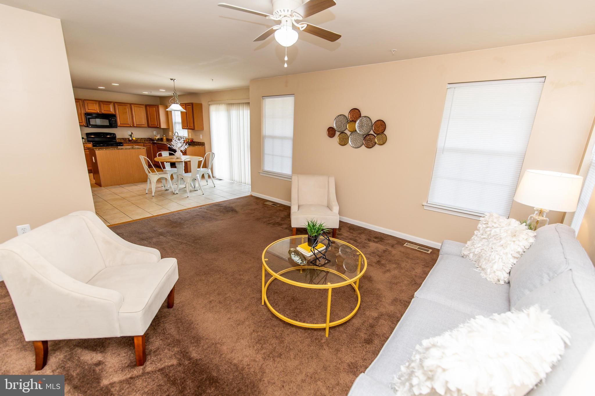 13400 Oaklands Manor Drive Laurel, MD 20708 - Photo 8 of 44 a living room with furniture and a chandelier