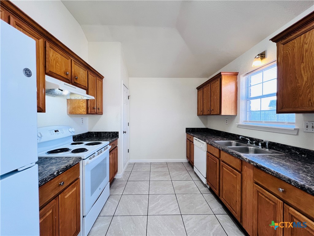 1704 Boydstun Loop Killeen, TX 76542 - Photo 5 of 11 a kitchen with stainless steel appliances granite countertop a stove a sink and a microwave