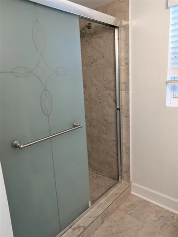 a bathroom with a glass shower door