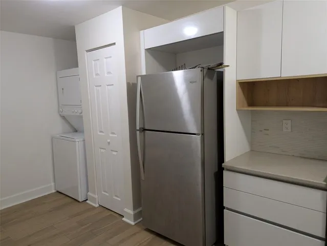 a metallic refrigerator freezer sitting in a kitchen