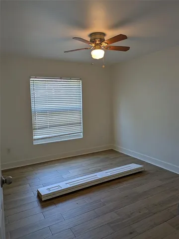 a view of wooden floor and windows in a room