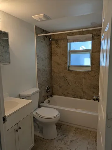 a bathroom with a toilet a sink and bathtub