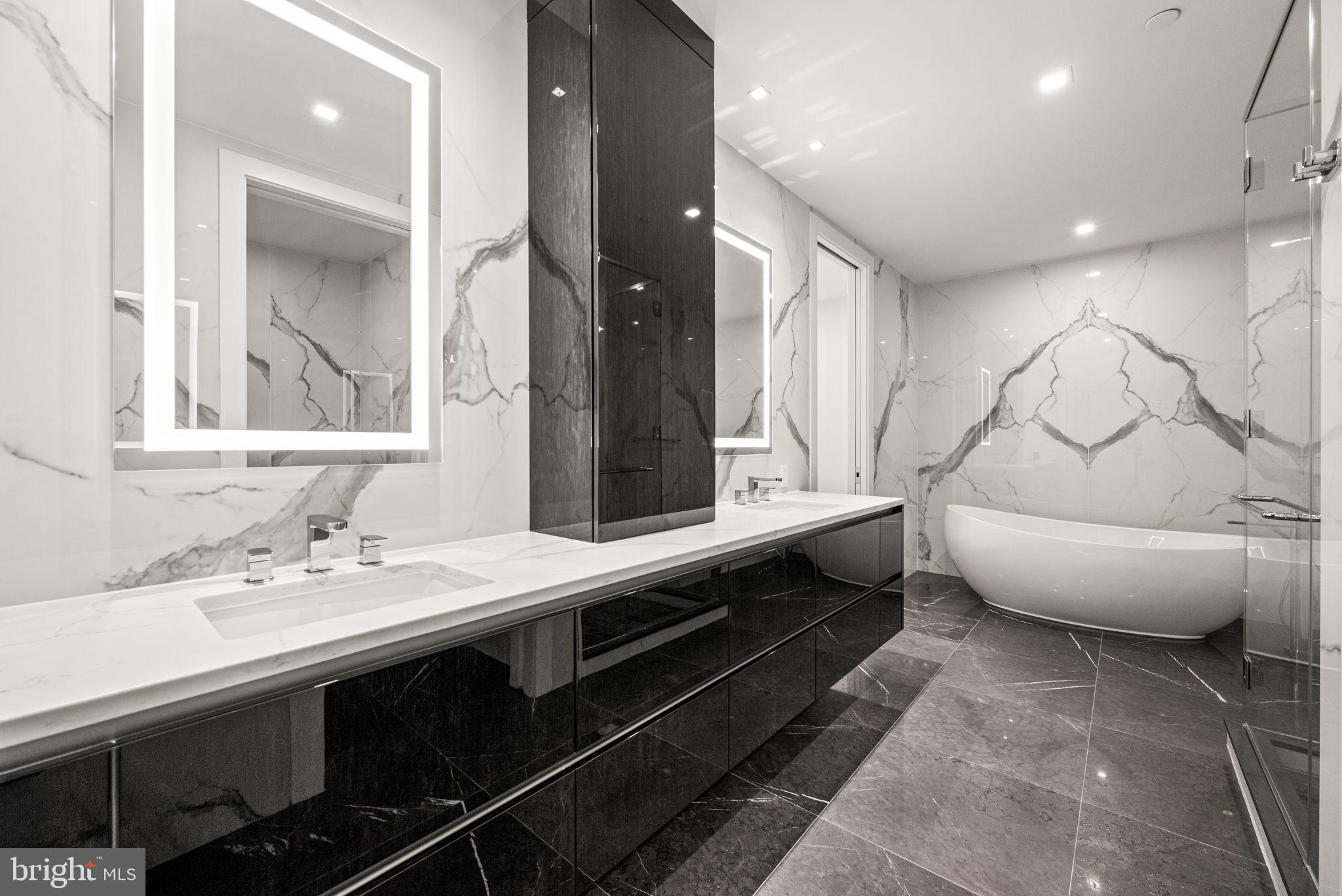 1911 Walnut Street, Unit 3404 Philadelphia, PA 19103 - Photo 13 of 37 a bathroom with a double vanity sink and a mirror