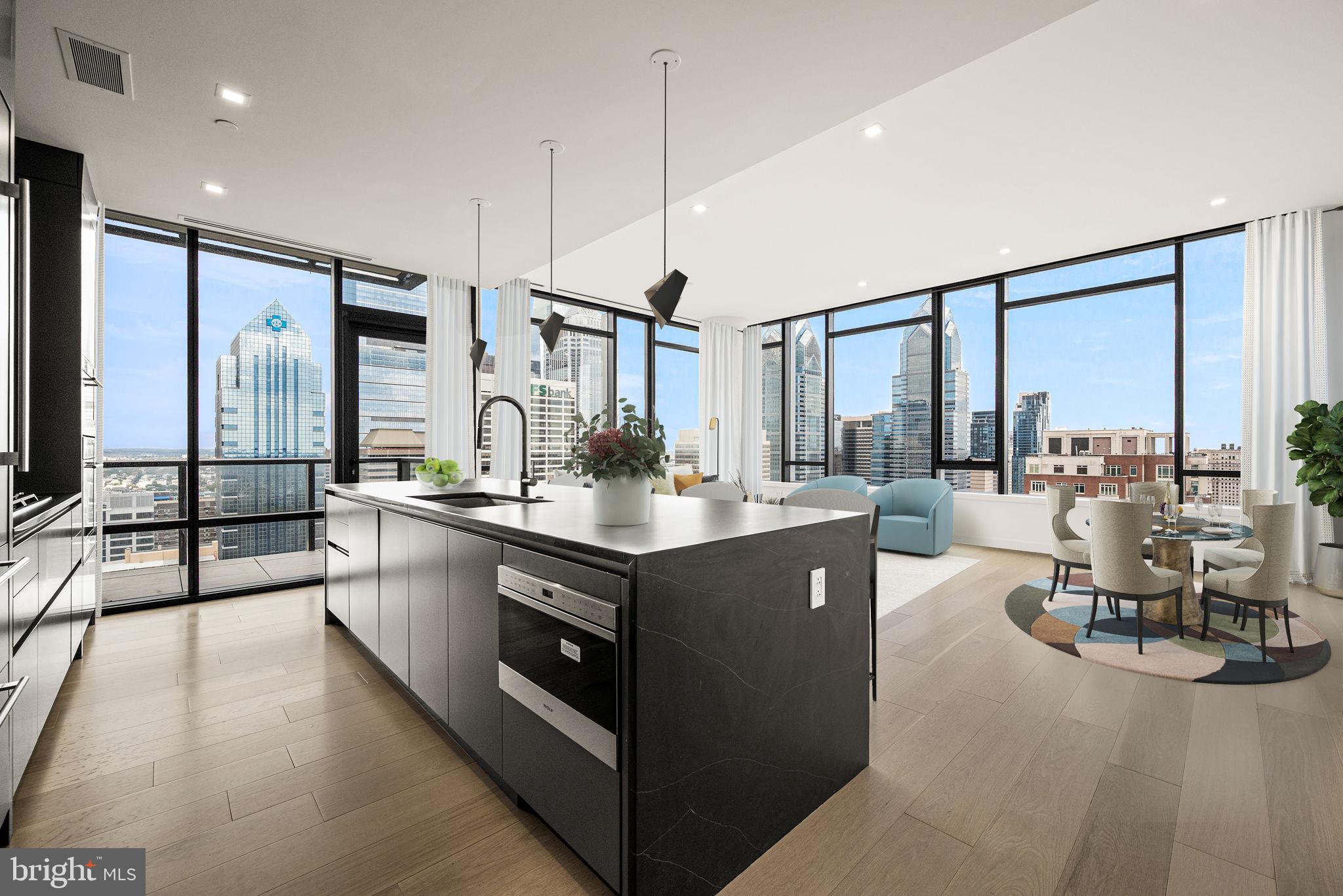 1911 Walnut Street, Unit 3404 Philadelphia, PA 19103 - Photo 3 of 37 a kitchen with stainless steel appliances kitchen island granite countertop a sink and a view of living room