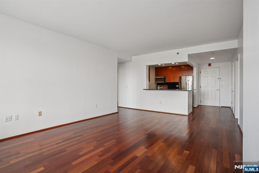 3110 City Place Edgewater, NJ 07020 - Photo 11 of 36 a view of a room with wooden floor and a flat screen tv