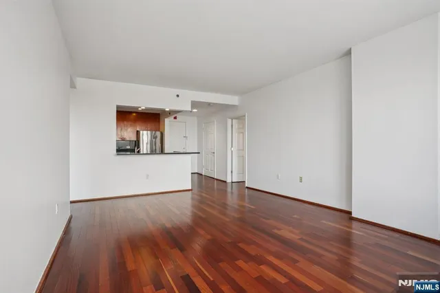 a view of an empty room and wooden floor