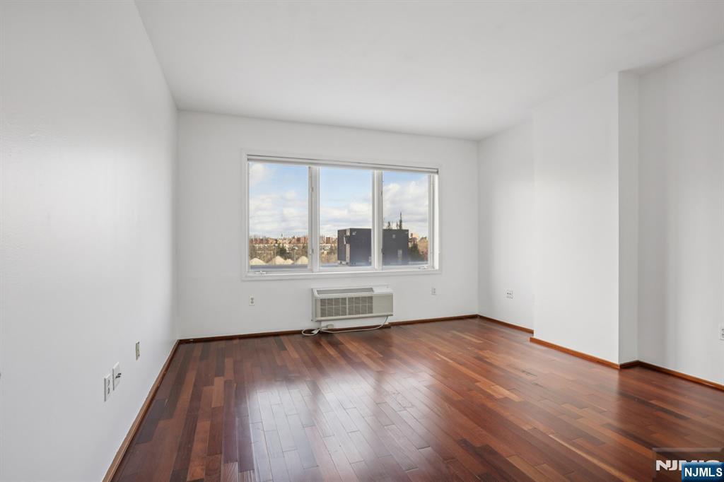 3110 City Place Edgewater, NJ 07020 - Photo 23 of 36 an empty room with wooden floor and a window