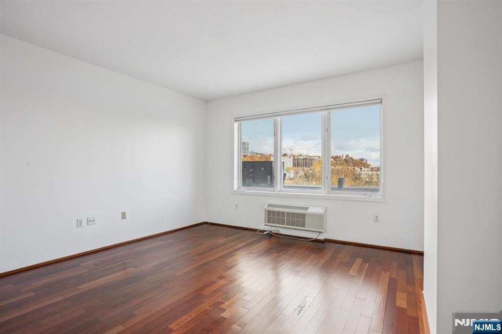 3110 City Place Edgewater, NJ 07020 - Photo 24 of 36 an empty room with wooden floor and windows