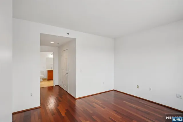 a view of a room with wooden floor and windows