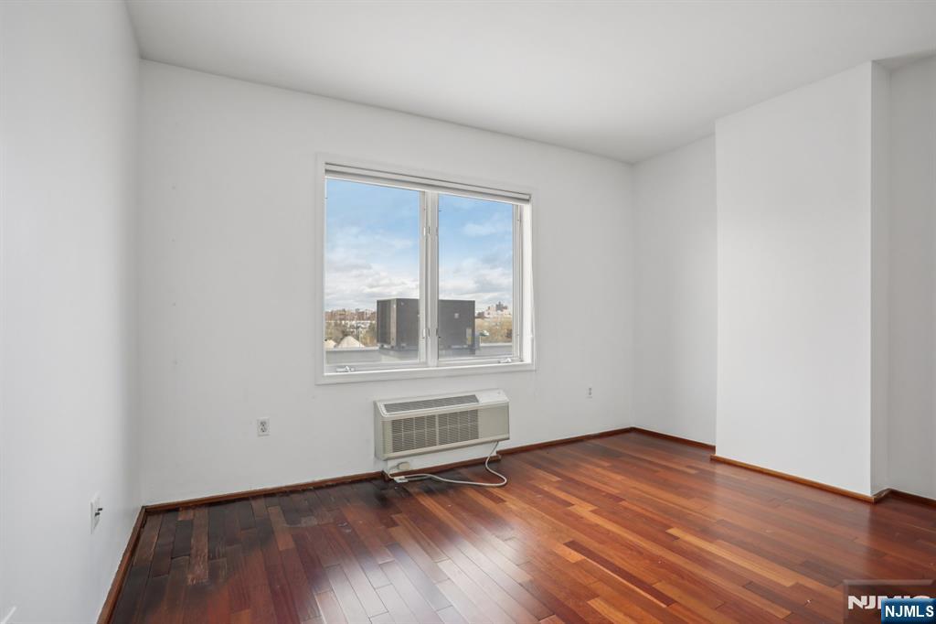 3110 City Place Edgewater, NJ 07020 - Photo 33 of 36 an empty room with wooden floor and windows