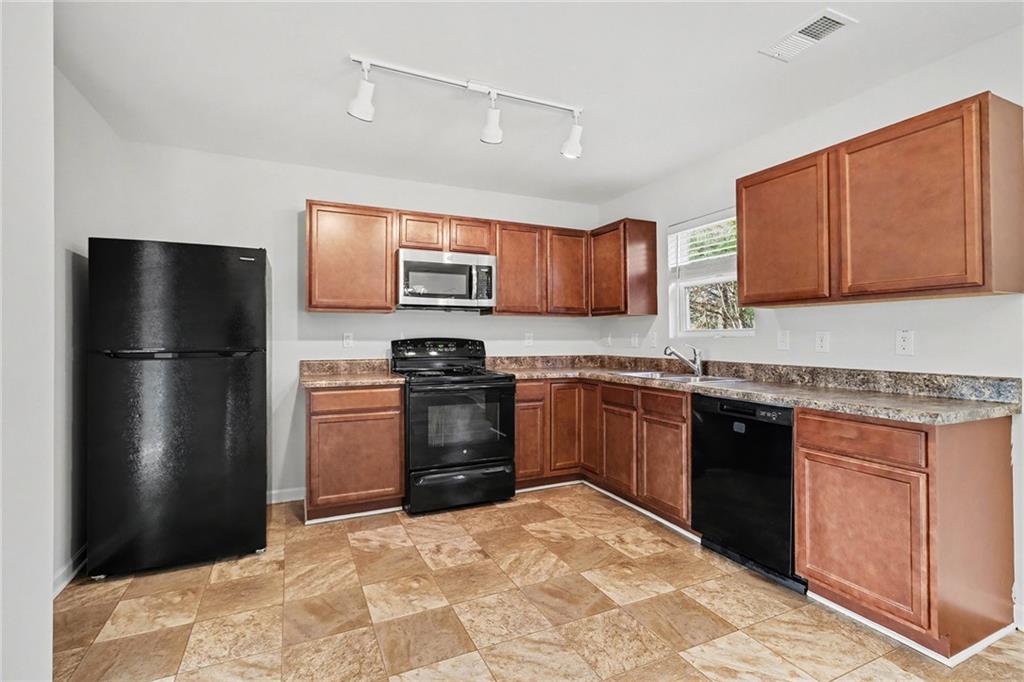 1235 To Lani Path Stone Mountain, GA 30083 - Photo 13 of 33 a kitchen with stainless steel appliances granite countertop a refrigerator stove and microwave