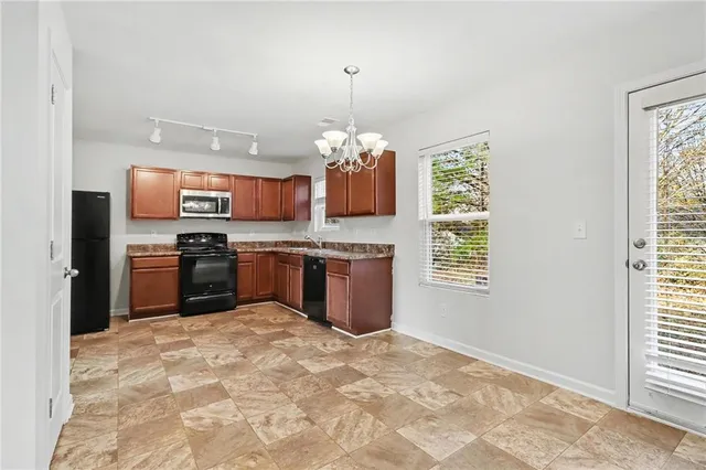 a kitchen with a stove a sink and a refrigerator