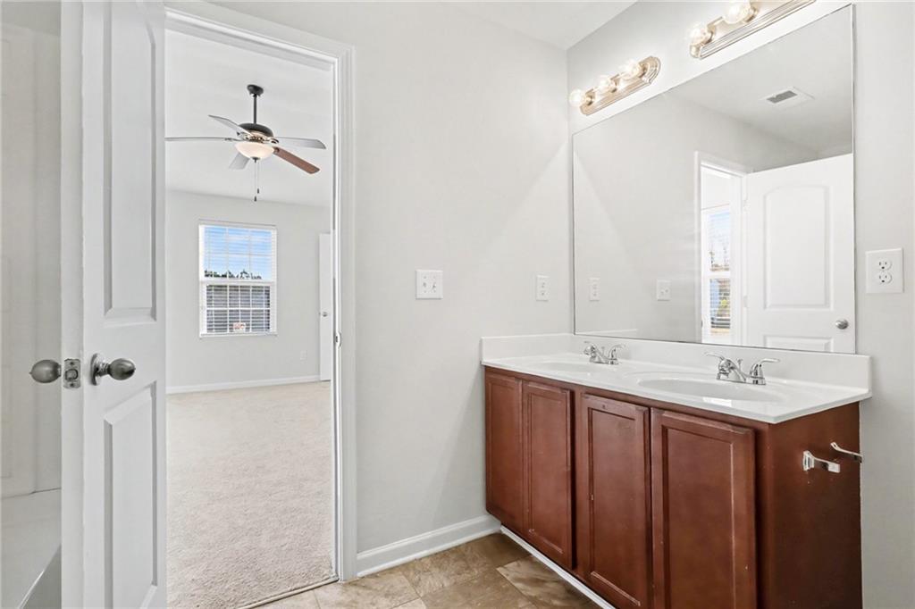 1235 To Lani Path Stone Mountain, GA 30083 - Photo 18 of 33 a bathroom with a double vanity sink and mirror
