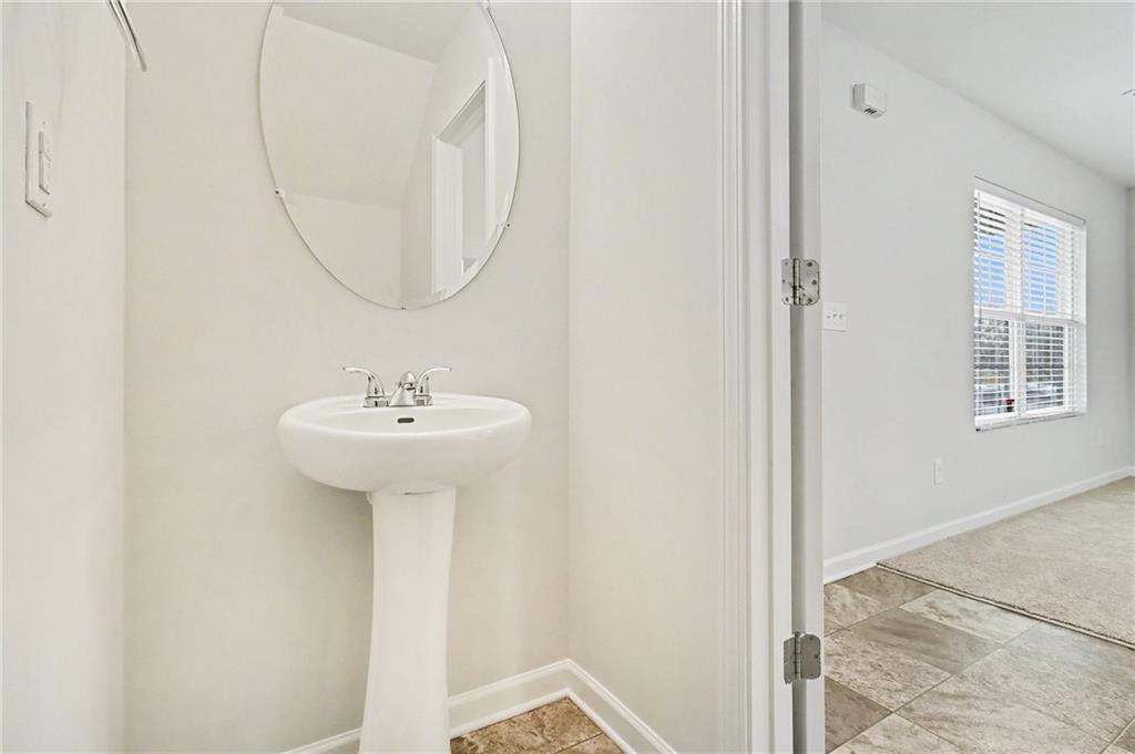 1235 To Lani Path Stone Mountain, GA 30083 - Photo 24 of 33 a bathroom with a sink and a mirror