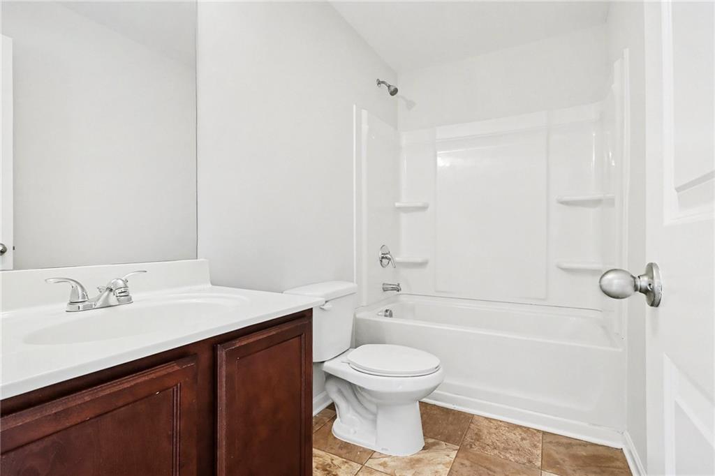 1235 To Lani Path Stone Mountain, GA 30083 - Photo 25 of 33 a bathroom with a sink a toilet and shower