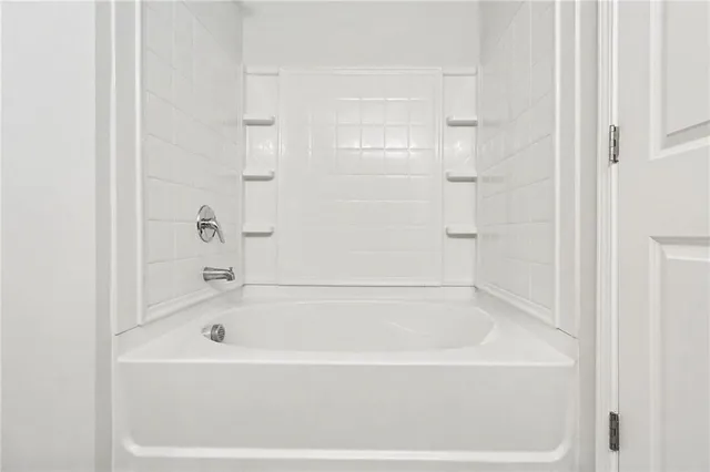 a white bath tub sitting next to a white sink
