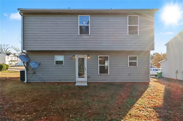 a view of a house with wooden fence