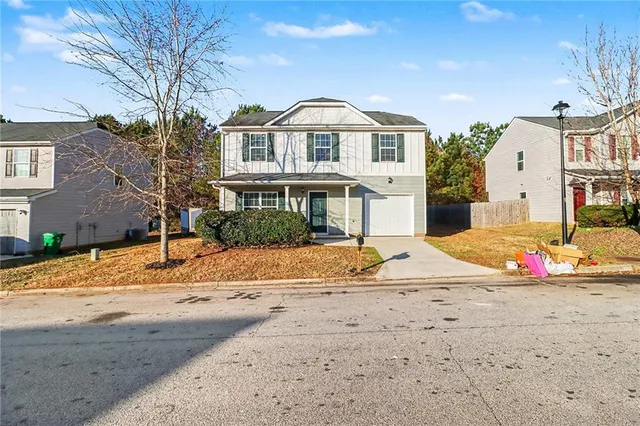 a view of a white house with a snow on the side of it
