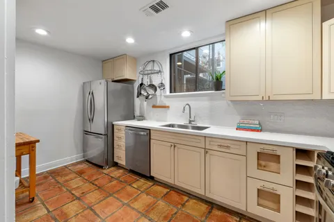 a kitchen with refrigerator cabinets and window