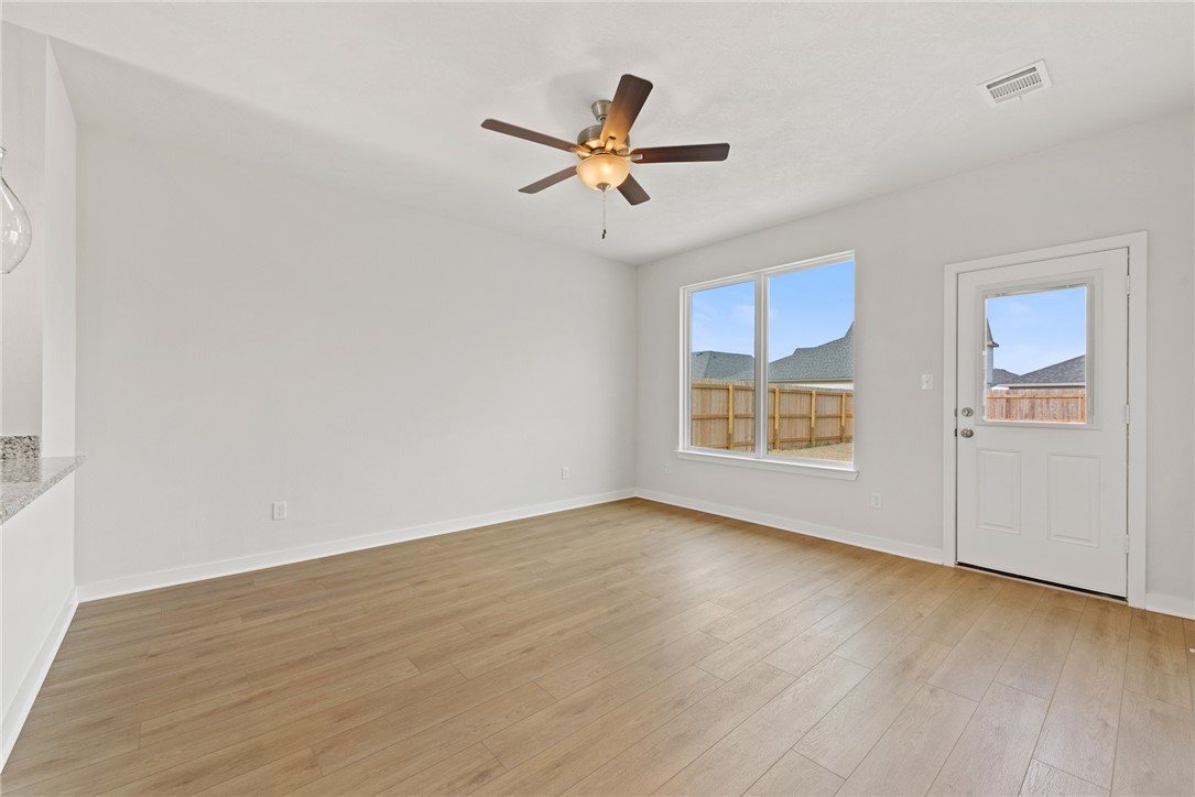 2412 Rooke Road Bryan, TX 77807 - Photo 17 of 35 a view of a livingroom with a ceiling fan and wooden floor