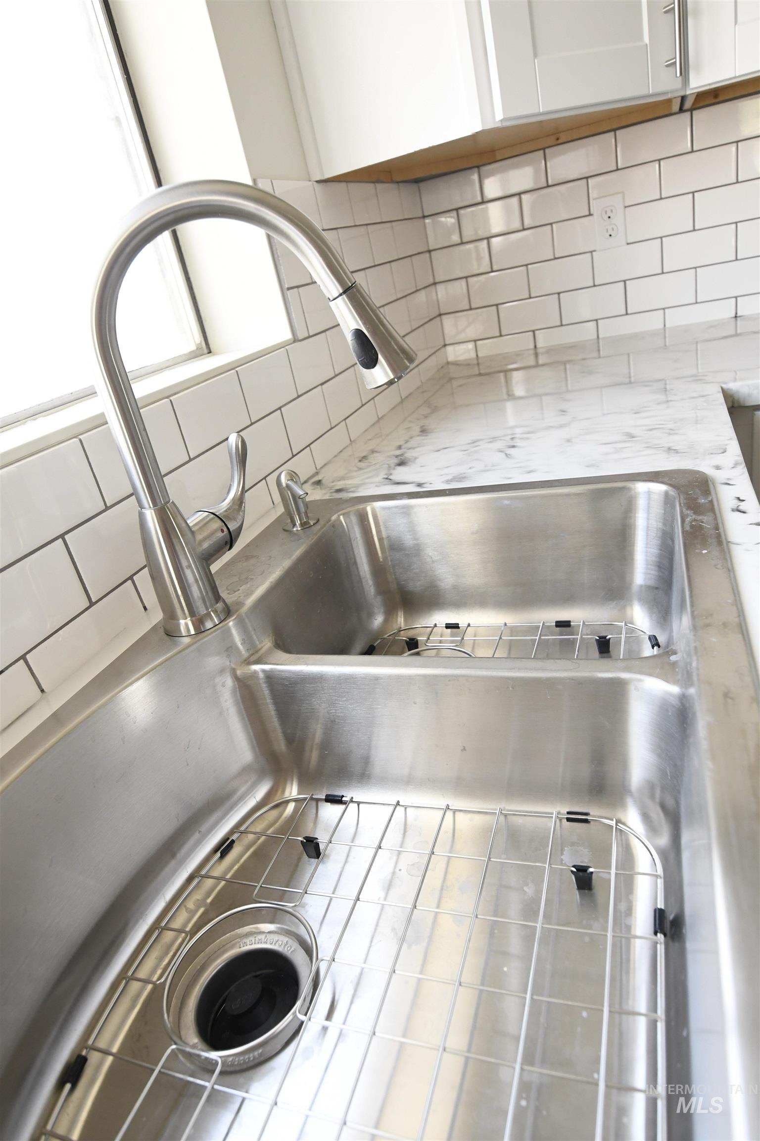 238 West Main Street St. Anthony, ID 83445 - Photo 7 of 9 Kitchen view of backsplash and white cabinetry