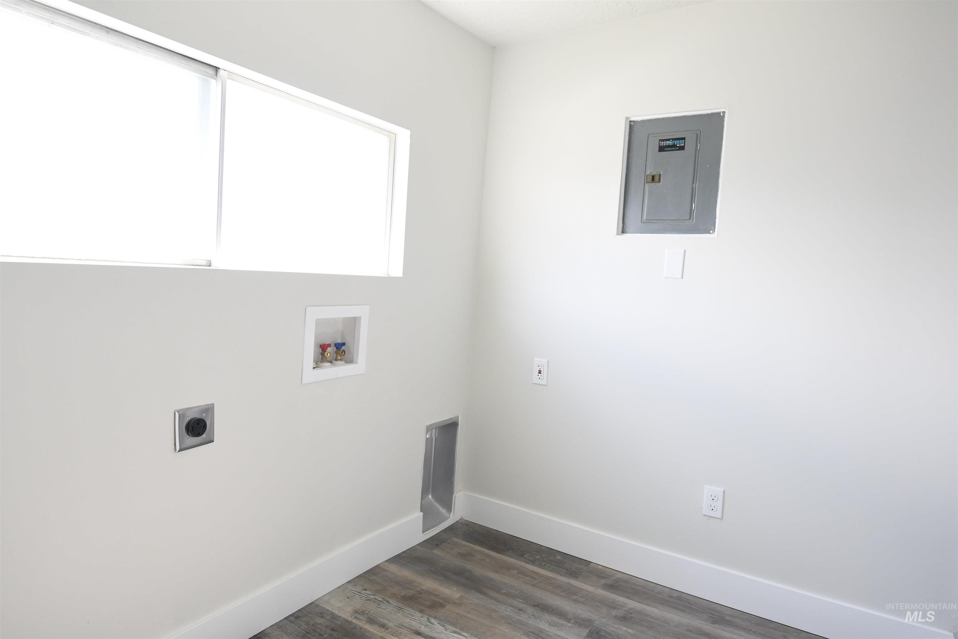 238 West Main Street St. Anthony, ID 83445 - Photo 8 of 9 Laundry room featuring hookup for an electric dryer, dark wood-style floors, washer hookup, and electric panel