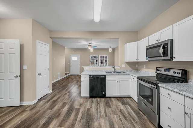 a kitchen with a stove top oven and sink